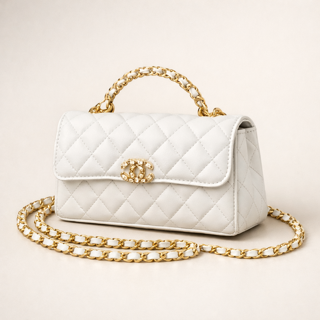 White quilted handbag with gold chain and clasp on a light background