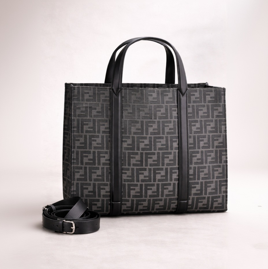 Black patterned tote bag with matching belt on a light gray background